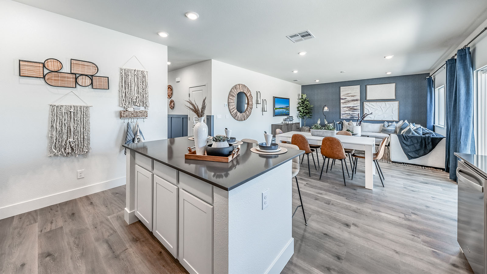 Kitchen island with white cabinets and dark countertops