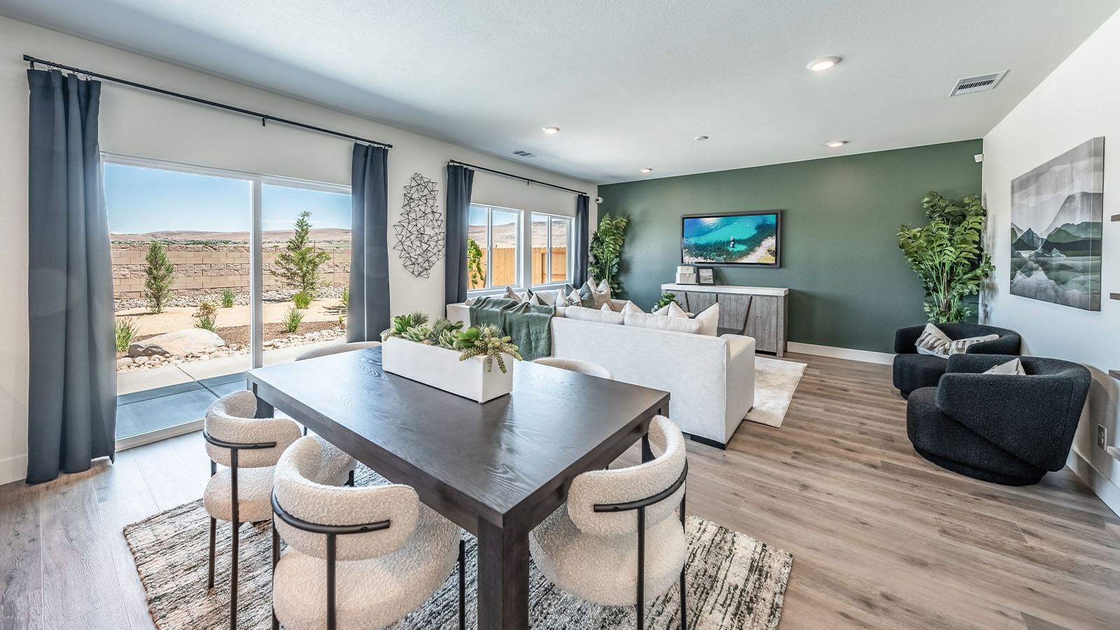 Dining and living area with large windows looking into back yard