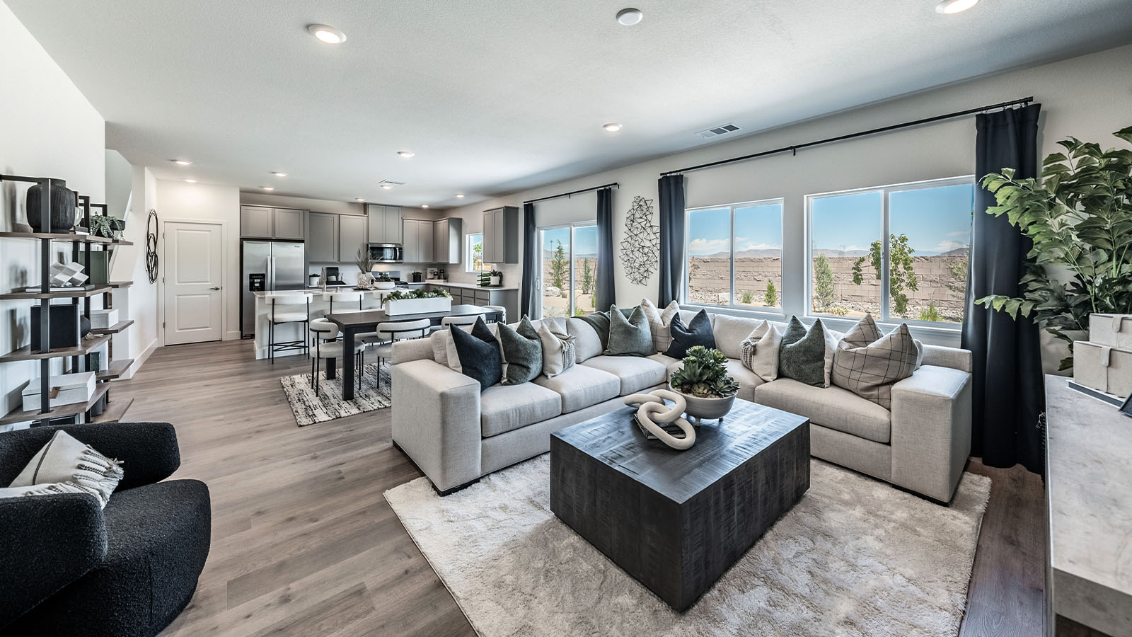 Open concept living space with large windows looking into back yard