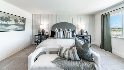 Modern primary bedroom with large windows