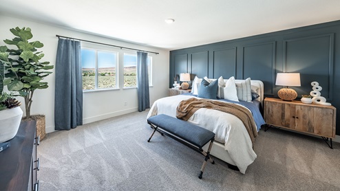 Large primary bedroom with carpet and large windows