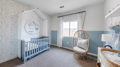 Nursery with large window and carpet