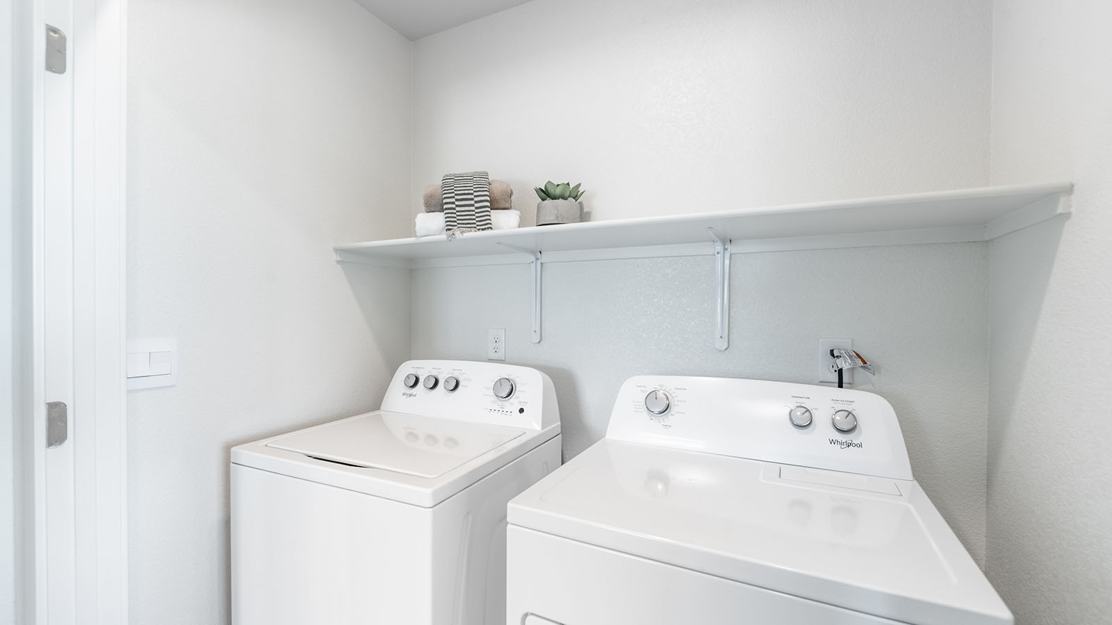 Separate laundry room closet with room for washer and dryer