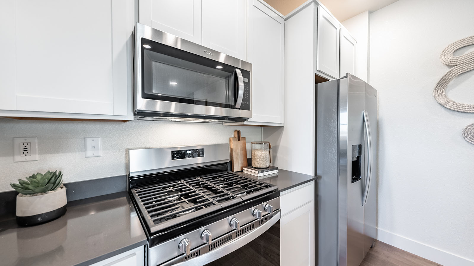 Stainless steel stove, microwave, and refrigerator in modern kitchen