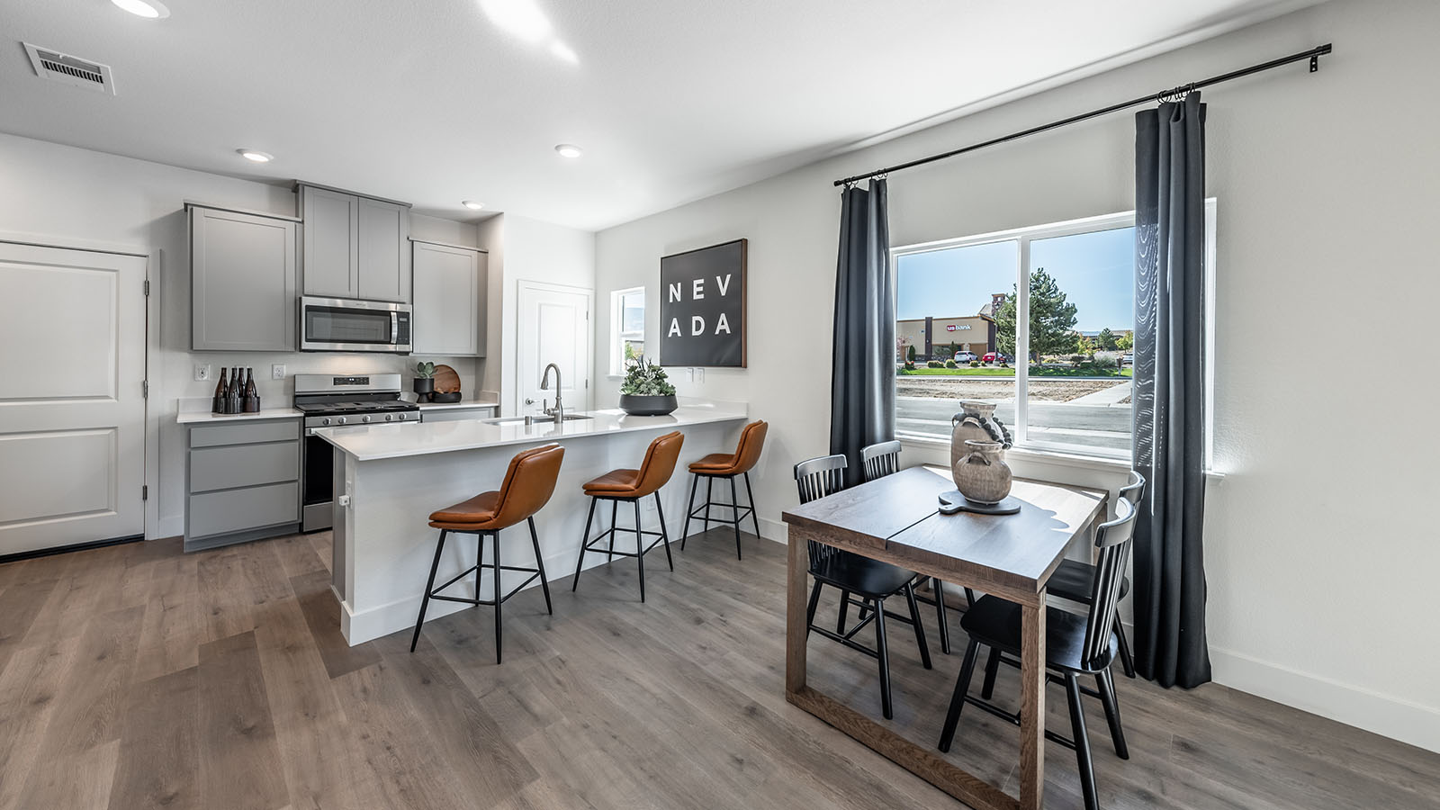 Kitchen and dining space with large window and kitchen peninsula