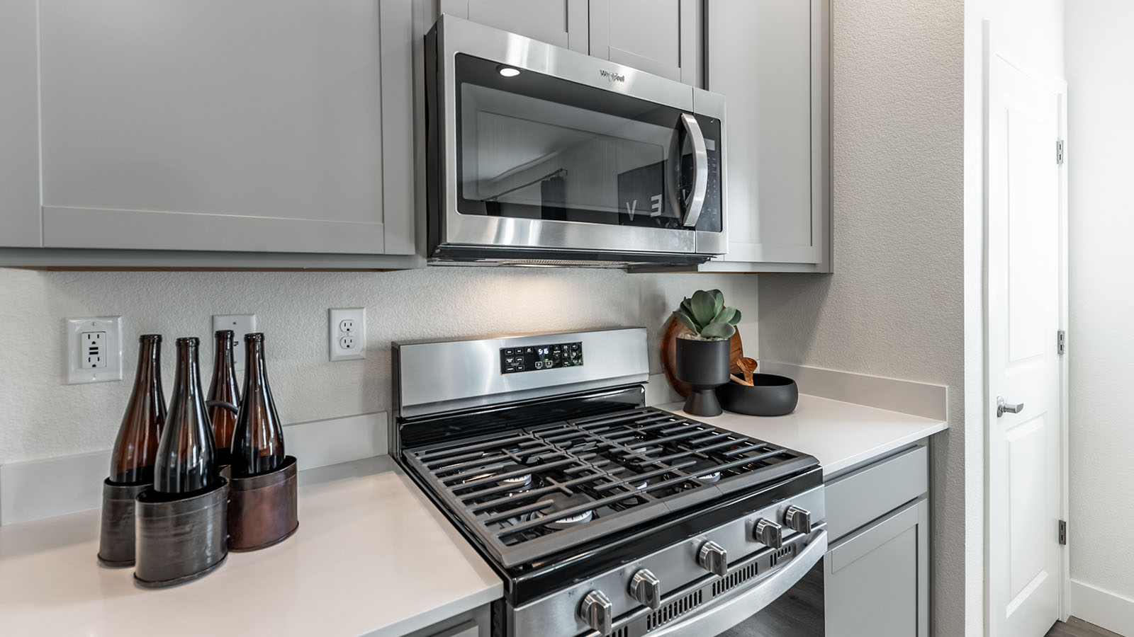 Stainless steel stove with microwave in kitchen
