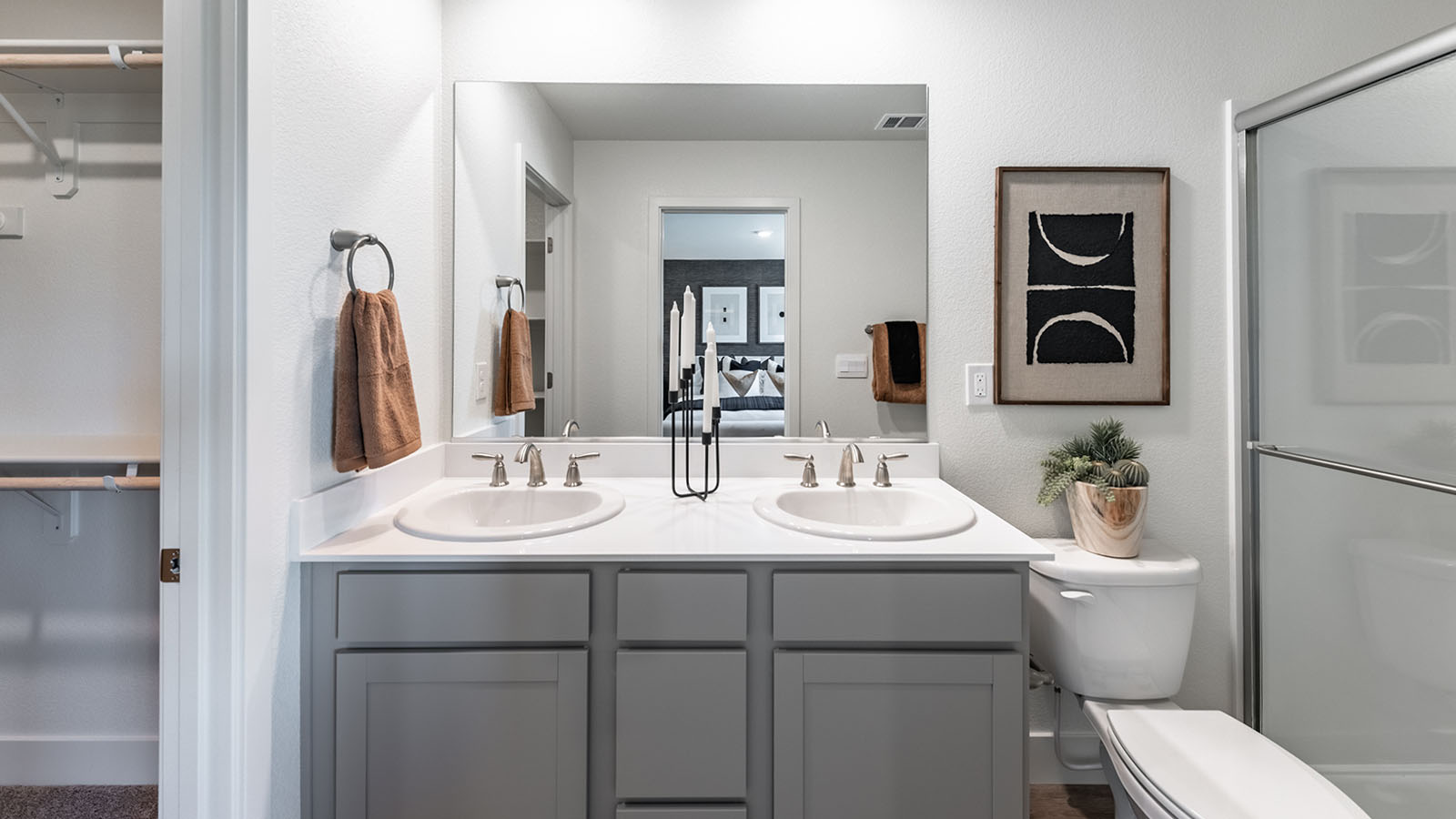 Modern cabinet vanity with two-sinks next to the walk-in closet