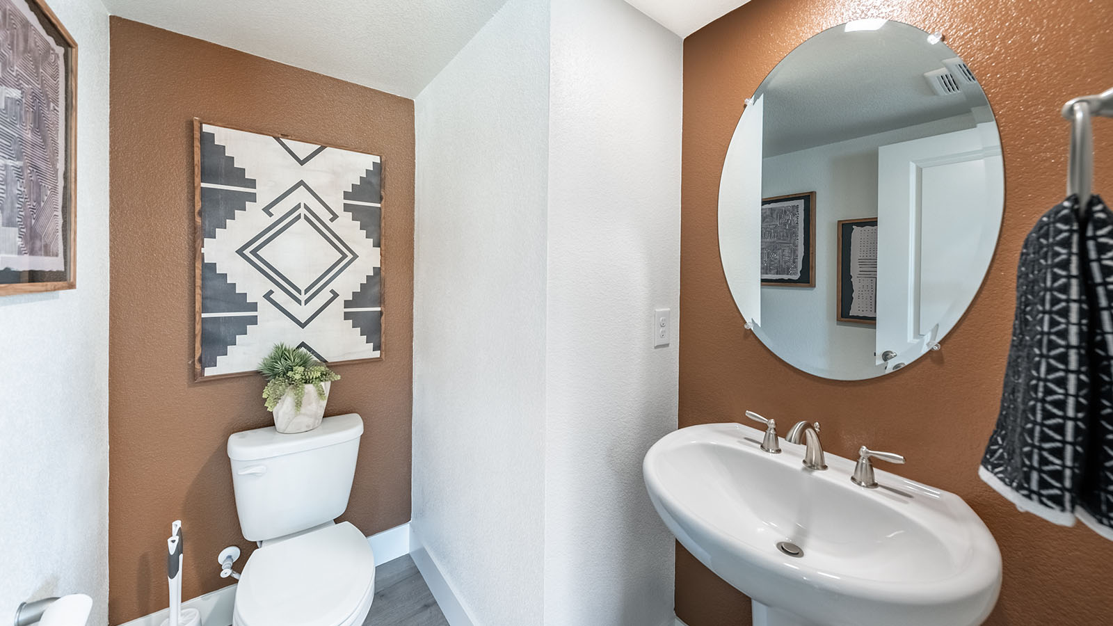 Secondary bathroom with modern accents and small sink with mirror