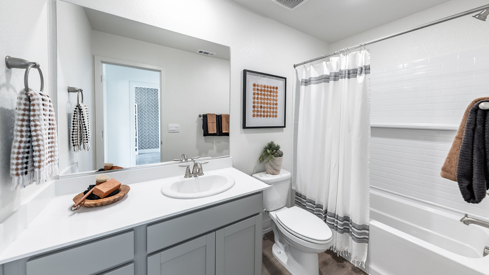 Secondary bathroom with built-in vanity and shower and bathtub combination