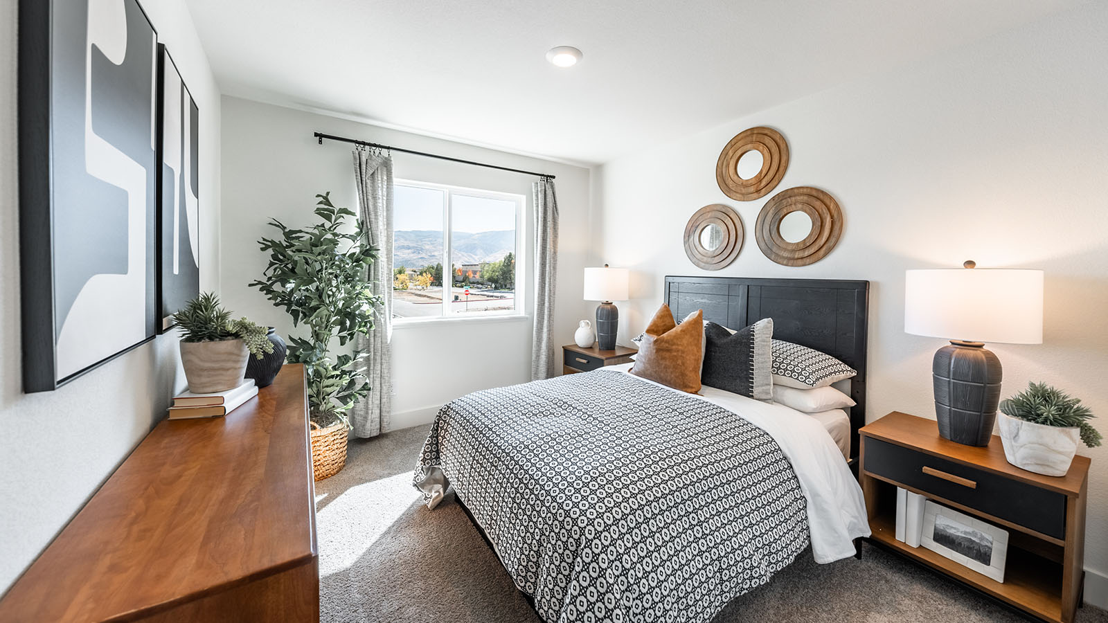 Guest bedroom with carpet and large window