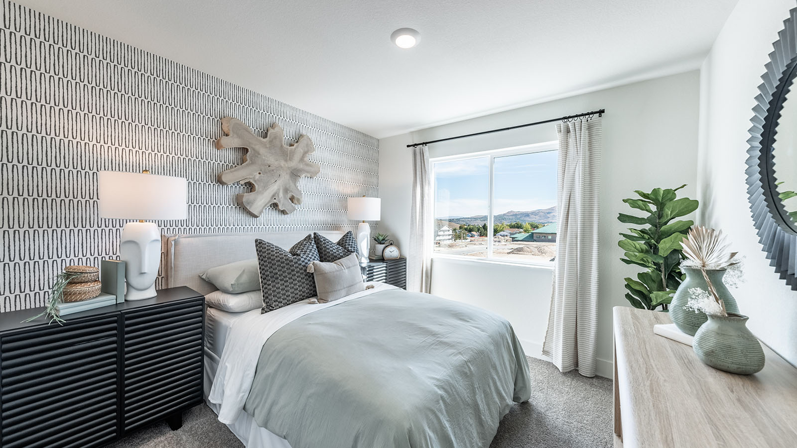 Secondary bedroom decorated as a guest room with large windows