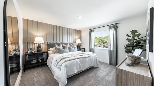 Large primary bedroom with carpet in the Walker floorplan