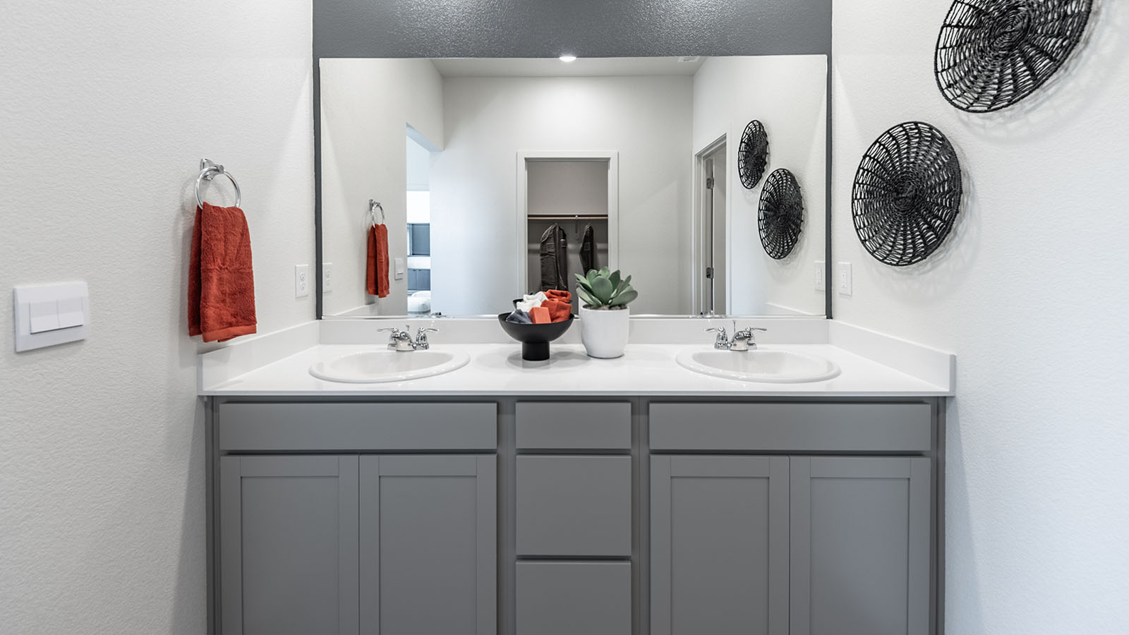 Double vanity in primary bathroom with large mirror