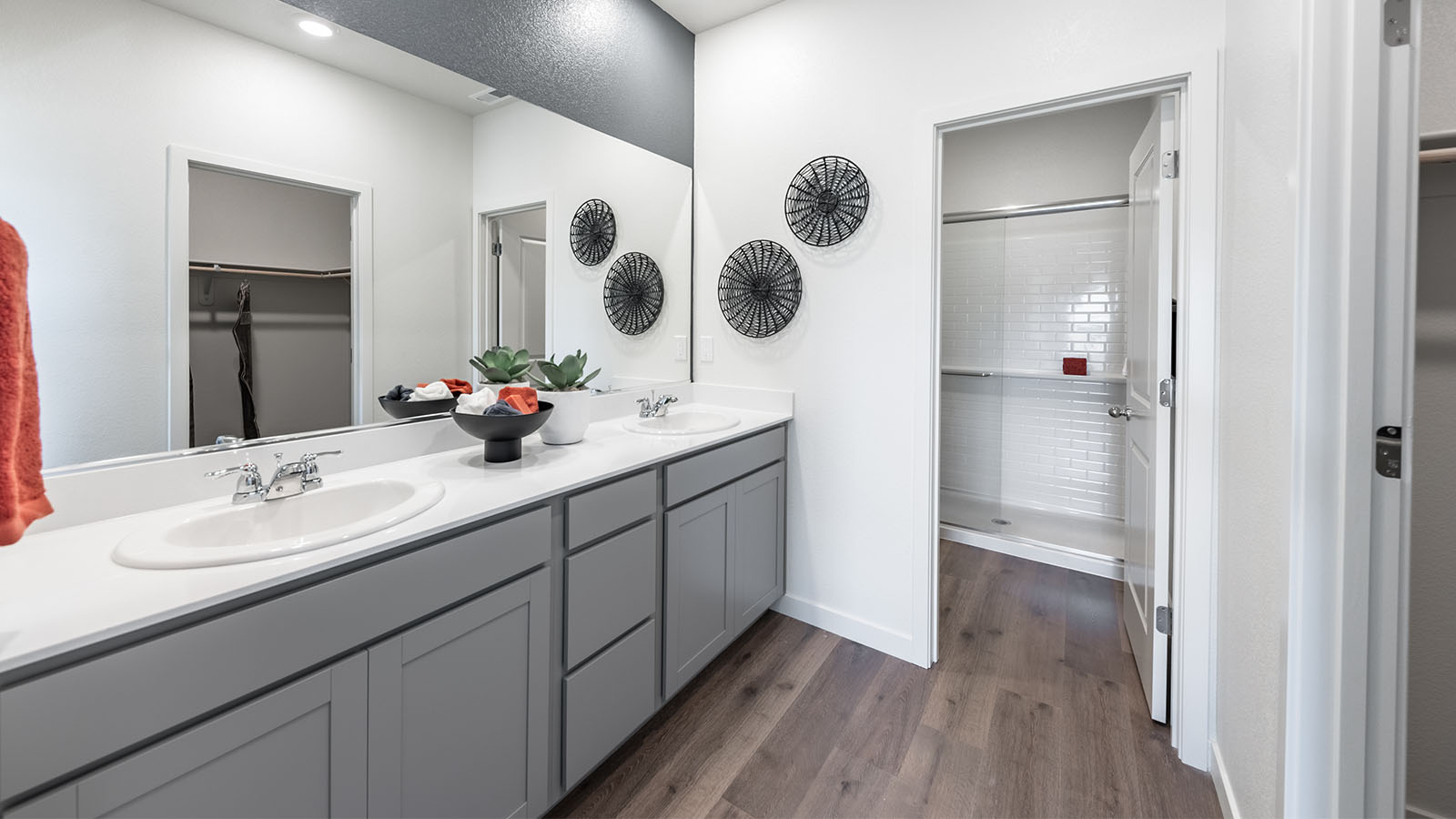 Primary bathroom with grey shaker-style cabinets and a double vanity