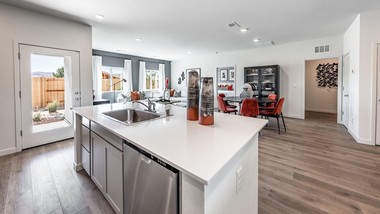 Kitchen island with built-in sink and dishwasher with light countertops