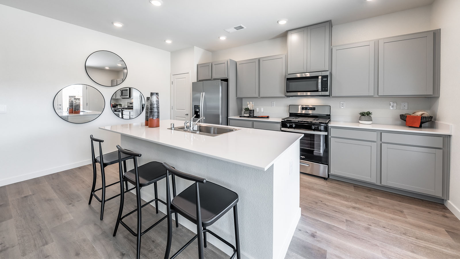 Bright kitchen with grey shaker-style cabinets and an island