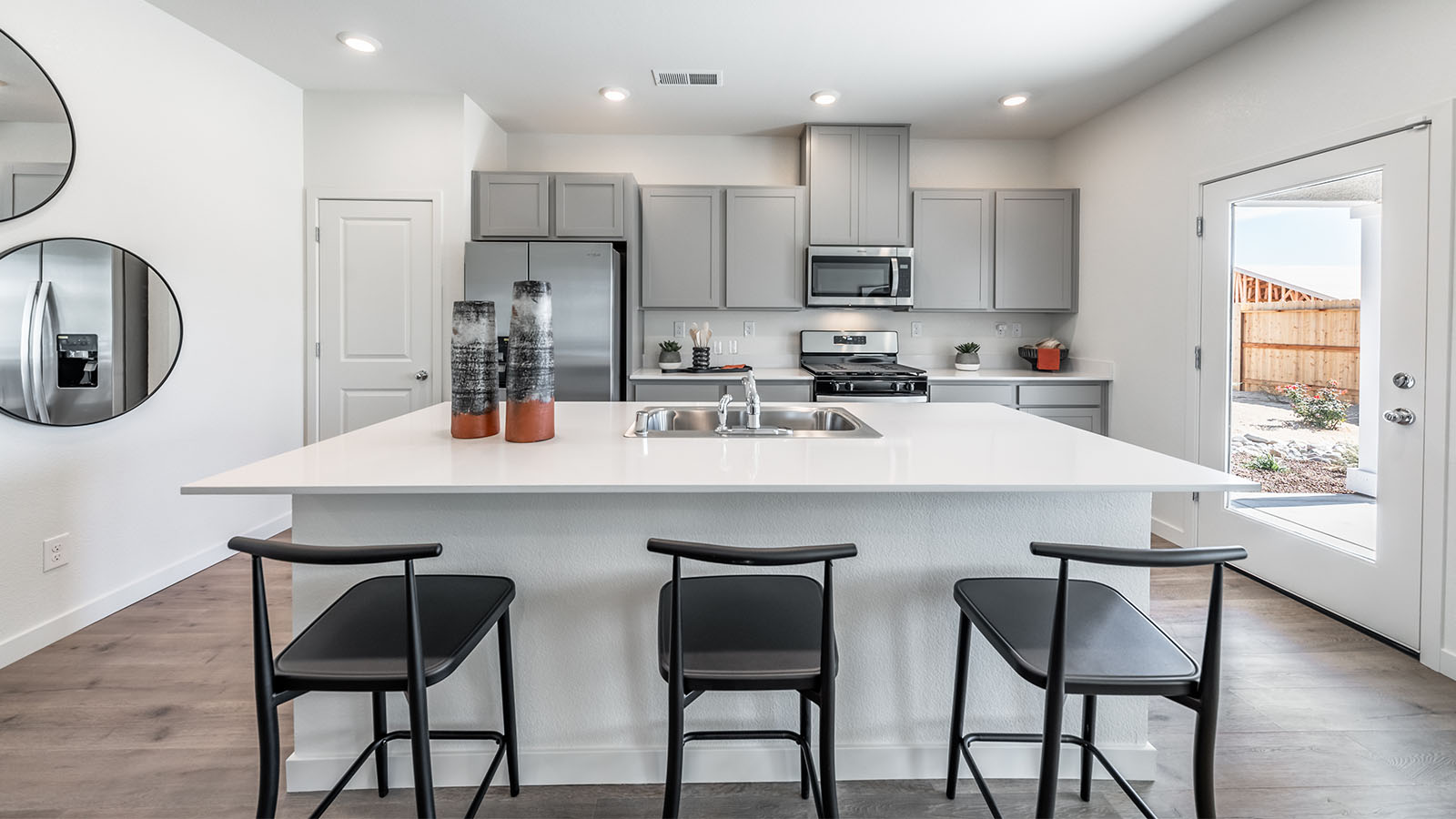 Kitchen island with room for three barstools and a sink built-in
