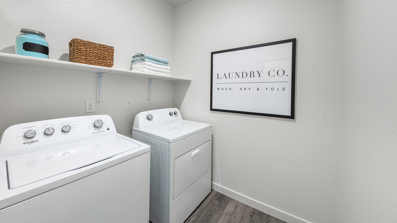 Separate laundry room with shelf above machines