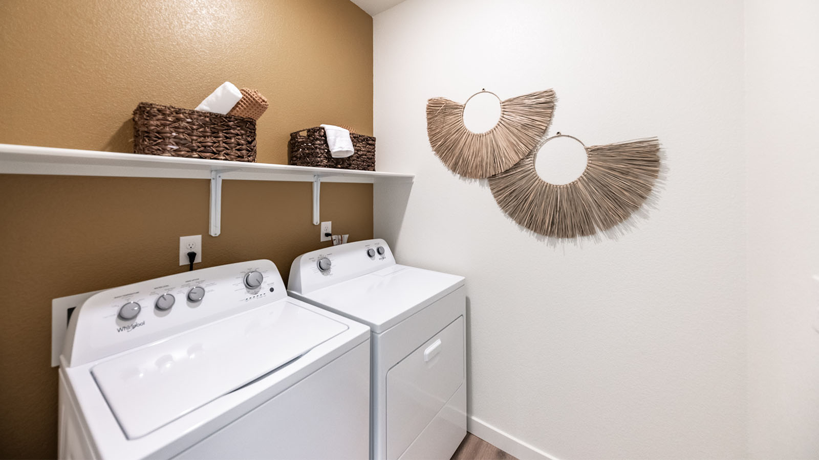 Separate laundry room with space for washer and dryer with a shelf above