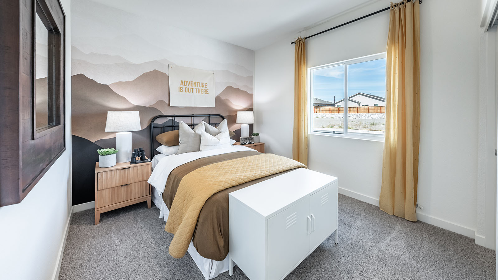 Cute secondary bedroom with carpeted floors and a large window