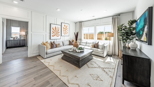Living room with large windows to brighten up the space leading to primary bedroom