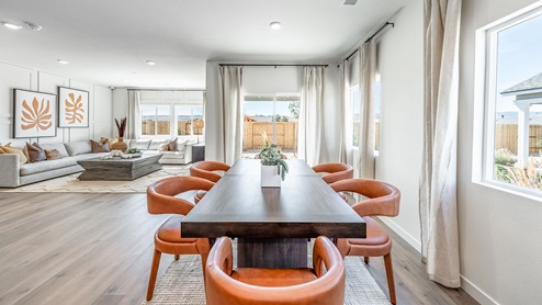 Dining space surrounded by windows and next to back patio door