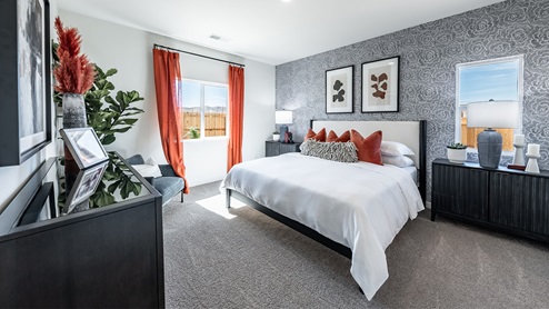 Large primary bedroom with carpet and large bright windows