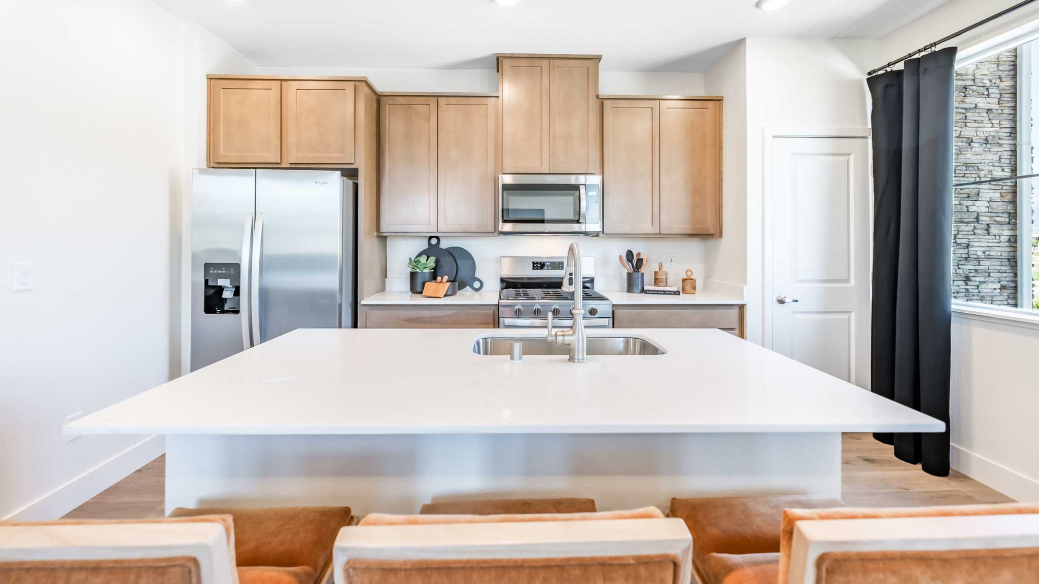 Kitchen island looking towards the cabinets and appliances
