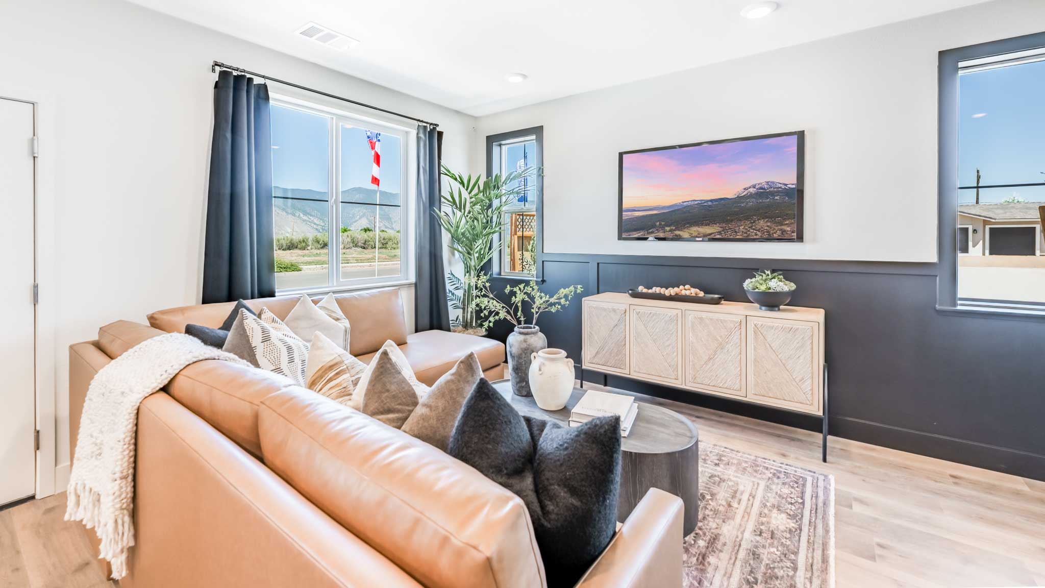 Bright open concept great room with a large window