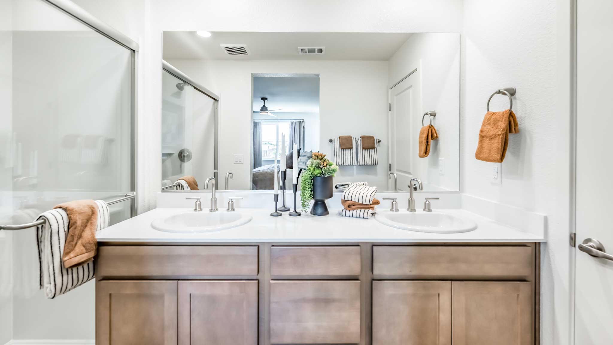Primary bathroom with a dual vanity and large mirror