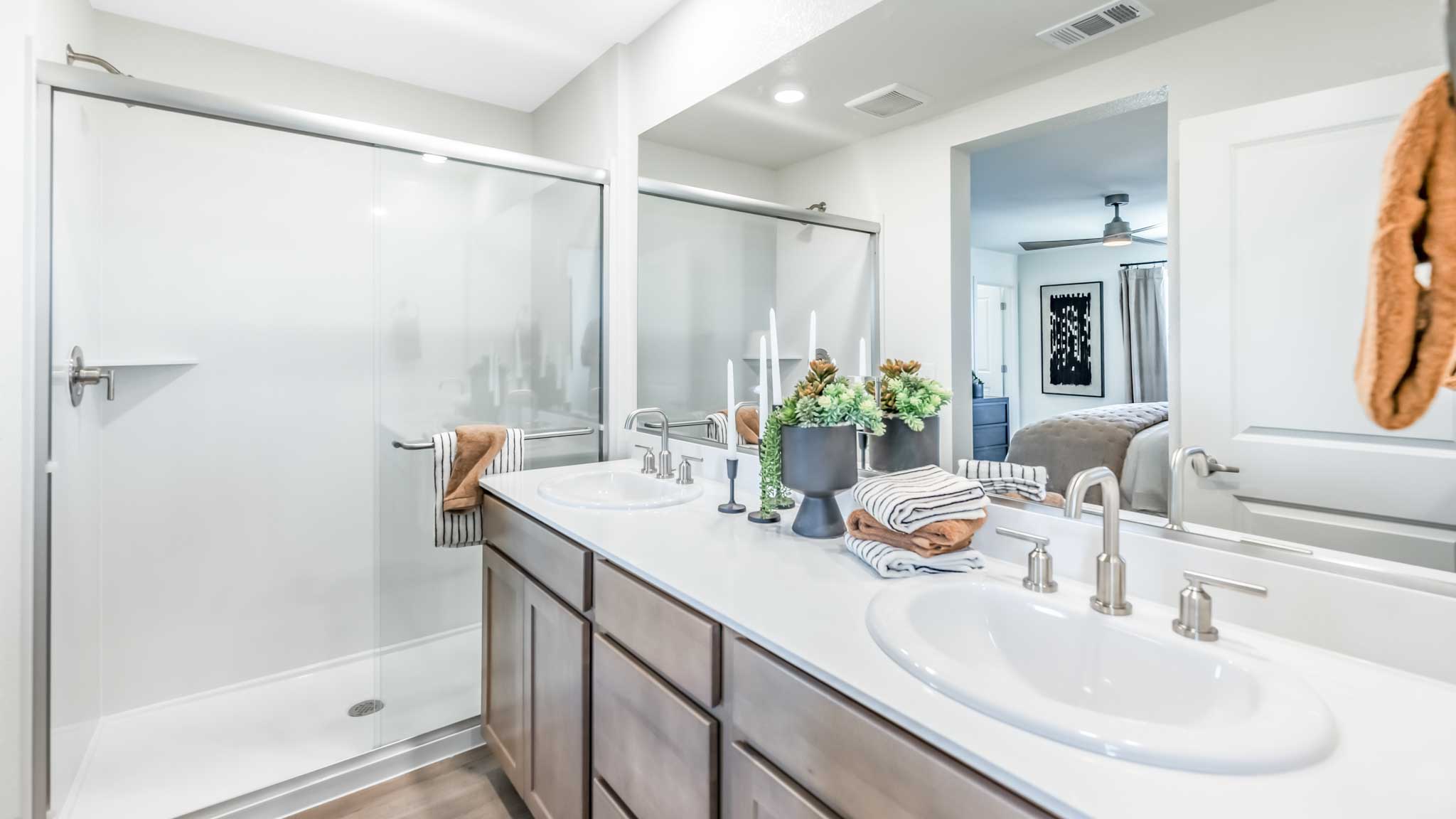 Primary bathroom with a dual vanity and walk in shower