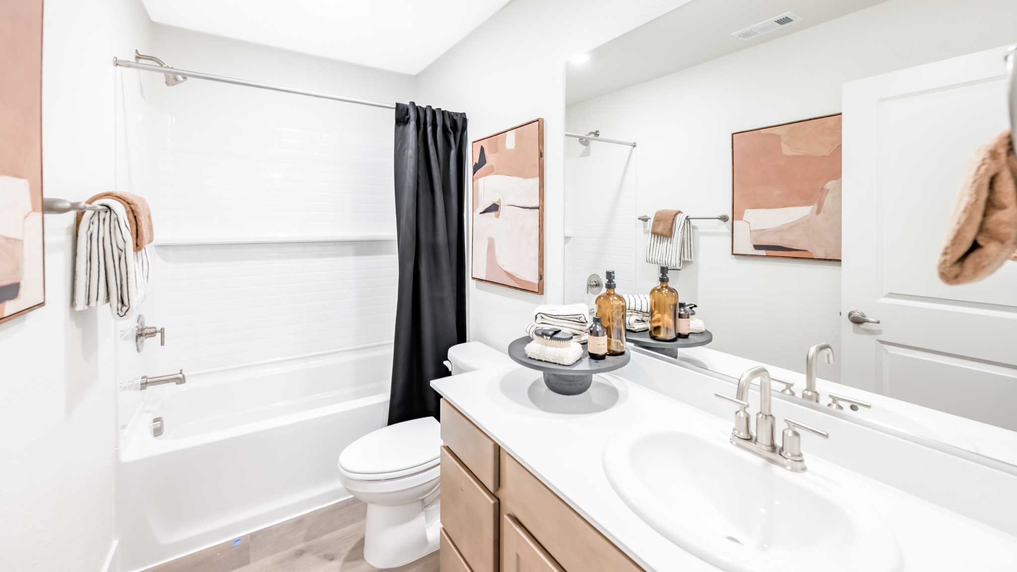 Secondary bathroom with vanity, toilet, and shower tub combo