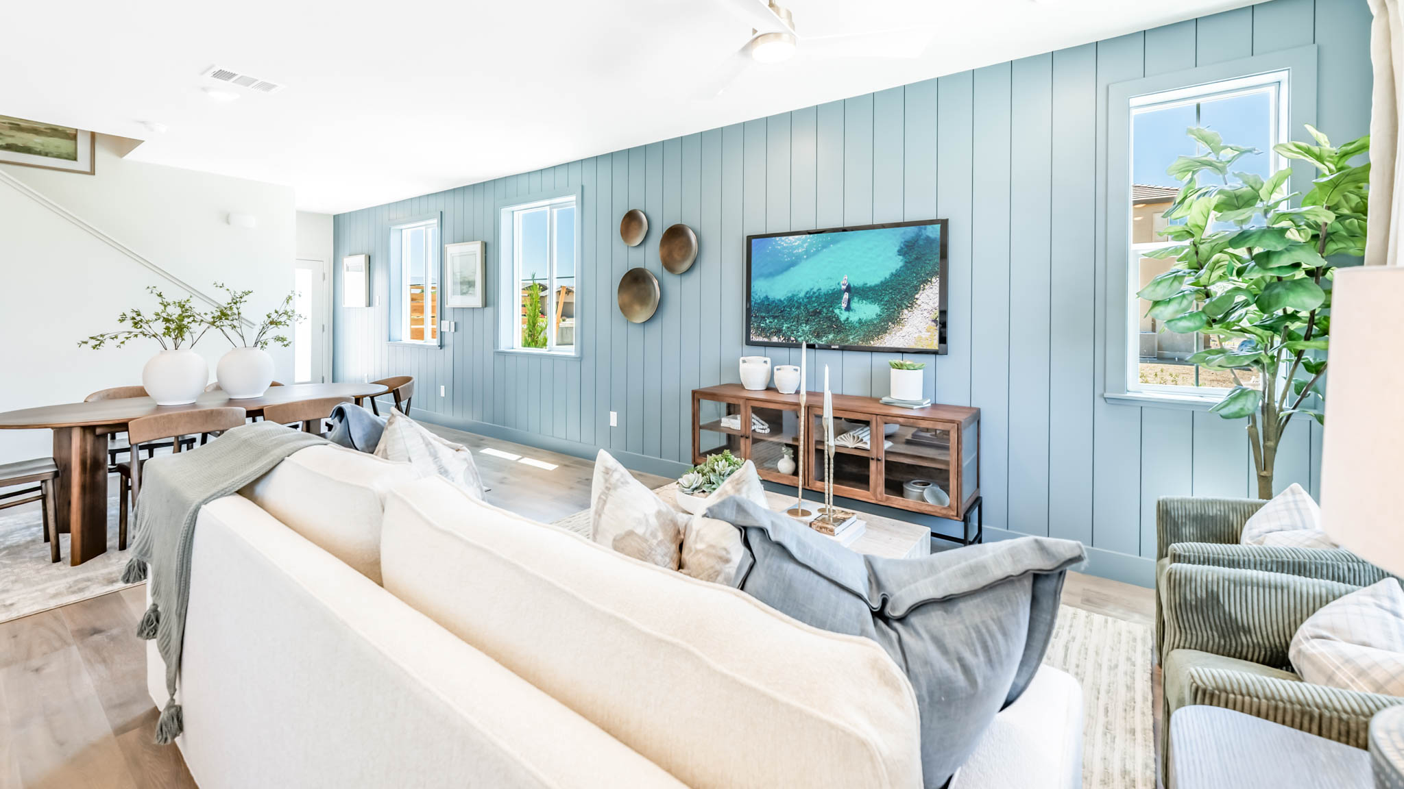 Open concept great room with blue accent wall