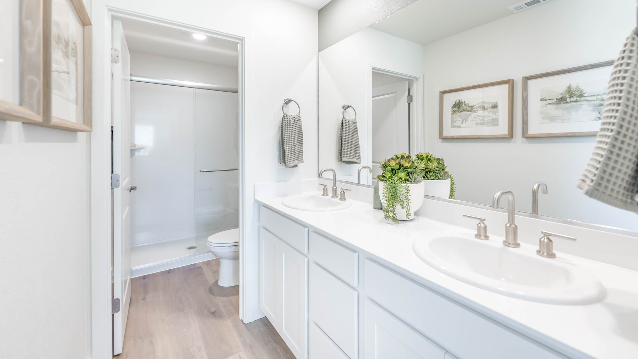 Primary bathroom with a dual vanity and separate room for the toilet and shower