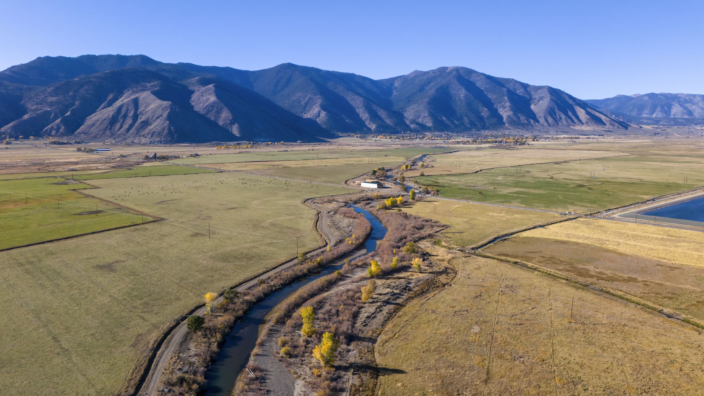 Drone photo of waterway with mountains in the background
