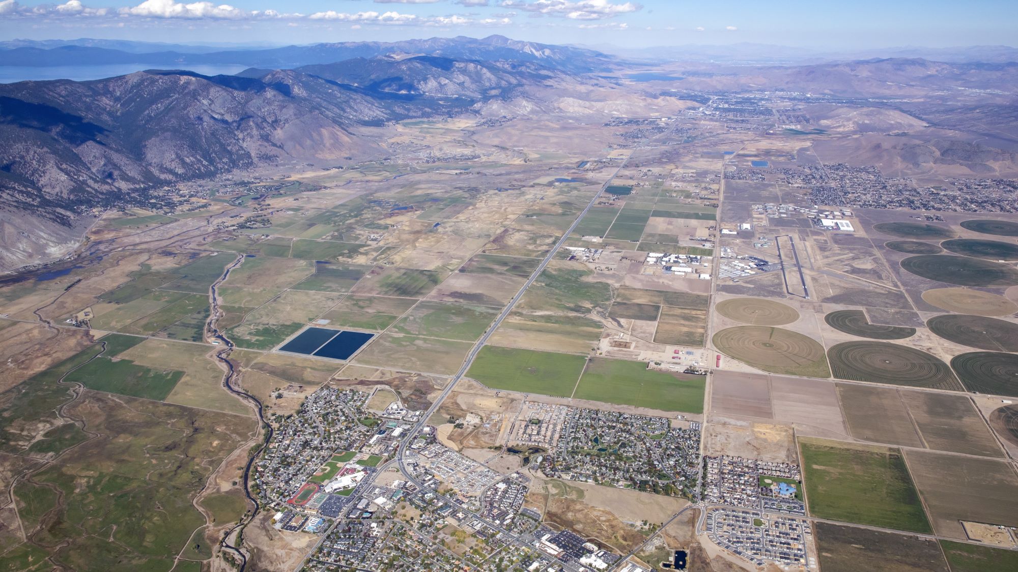 Aerial of Minden with Lake Tahoe and mountains in the background