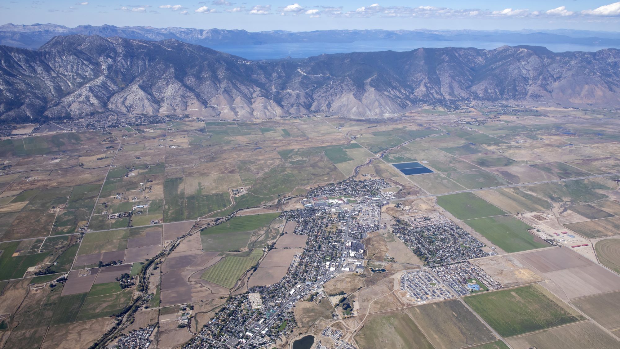 Aerial of Minden with Lake Tahoe and mountains in the background