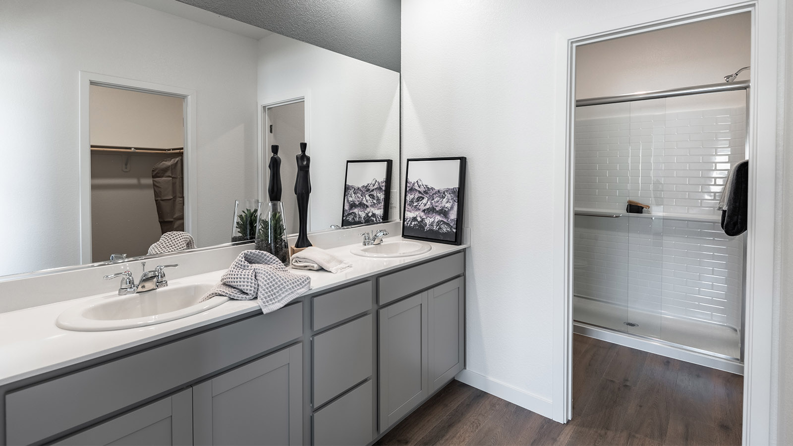 Double vanity with large mirror mounted above the sink in primary bathroom