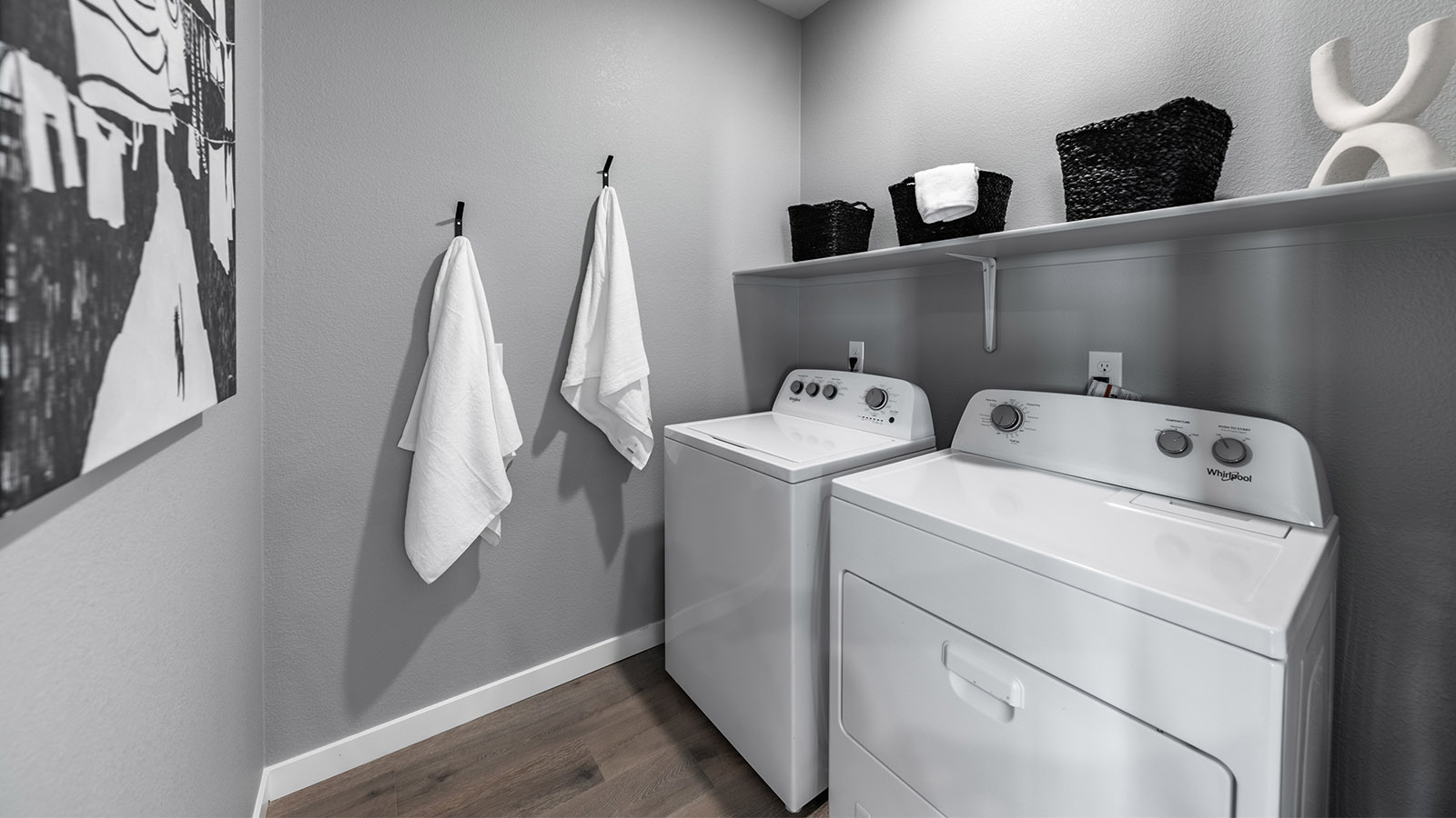 Separate laundry room with shelf above full-sized machines