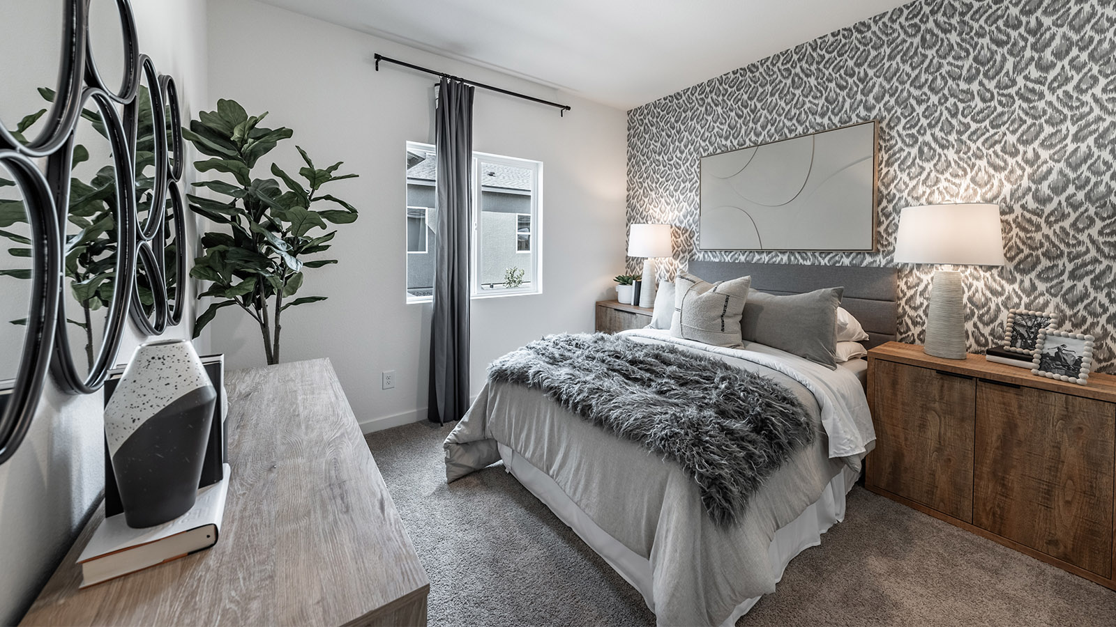 Carpeted secondary bedroom with large window