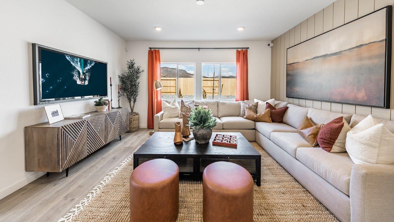 Large living area with a large window and room for a sectional couch