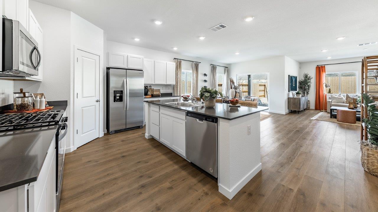 Spacious kitchen featuring an island with built-in dishwasher and sink