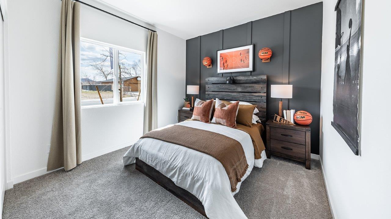 Modern secondary bedroom with carpet and large window