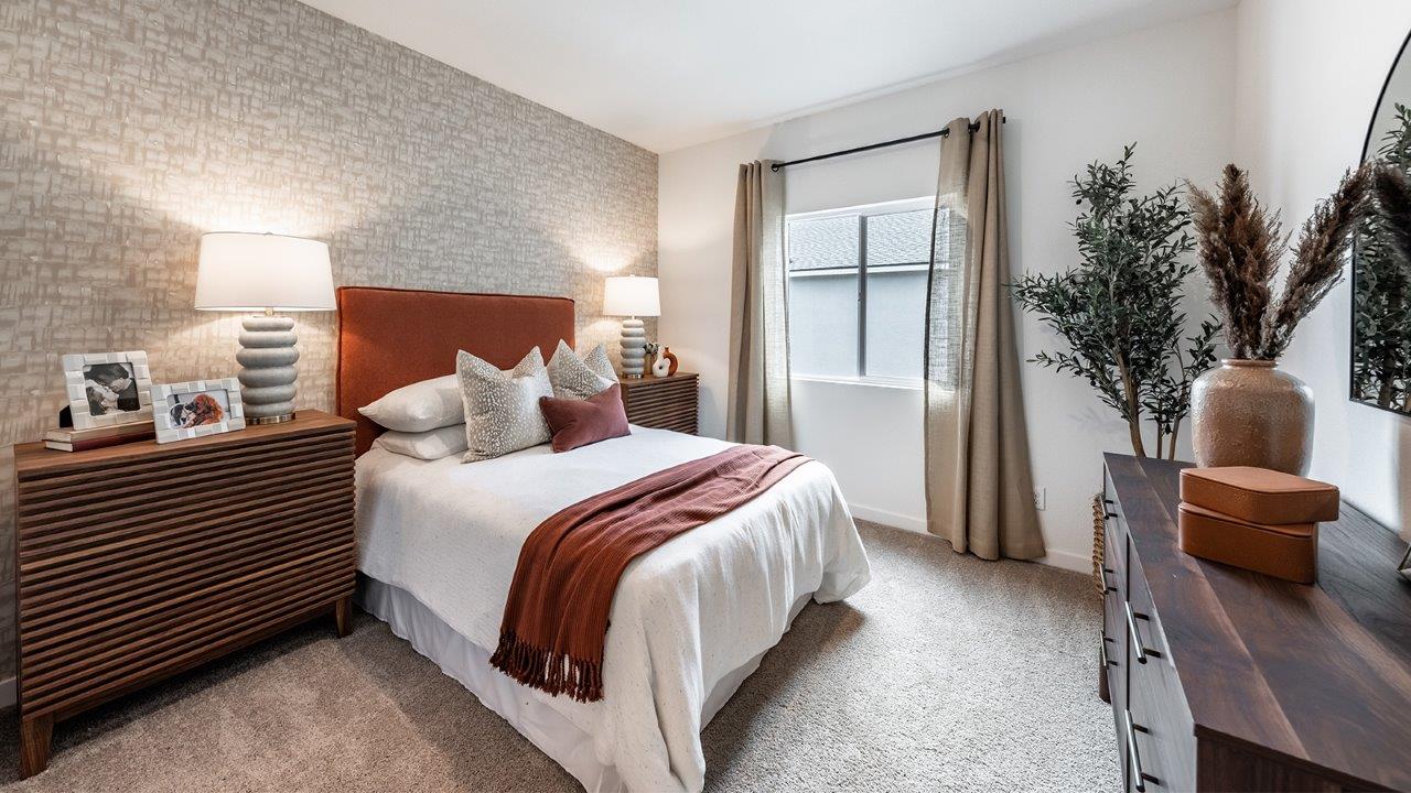 Secondary bedroom with carpet and large window
