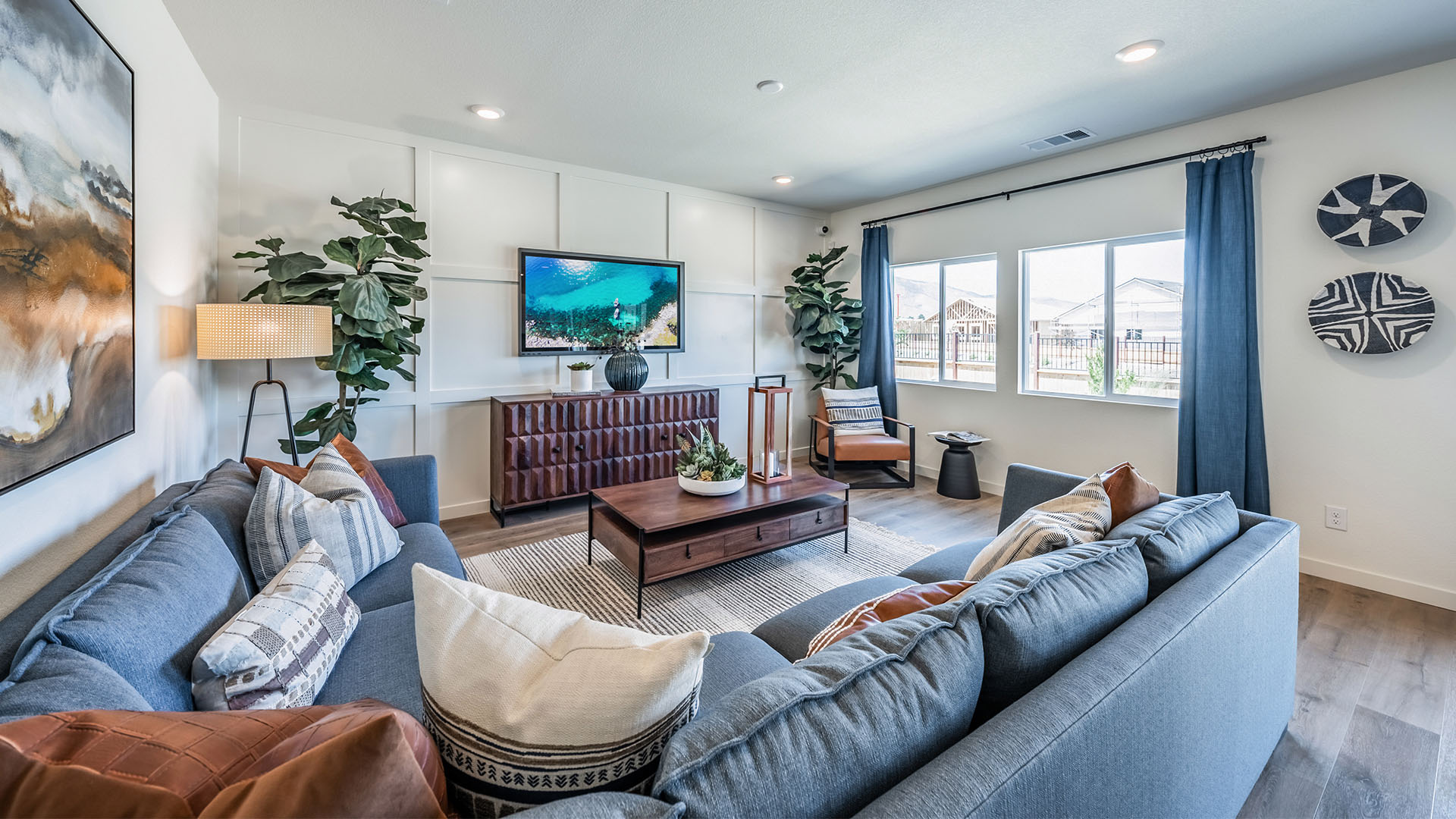 Living room with space for a large sectional couch and large bright windows