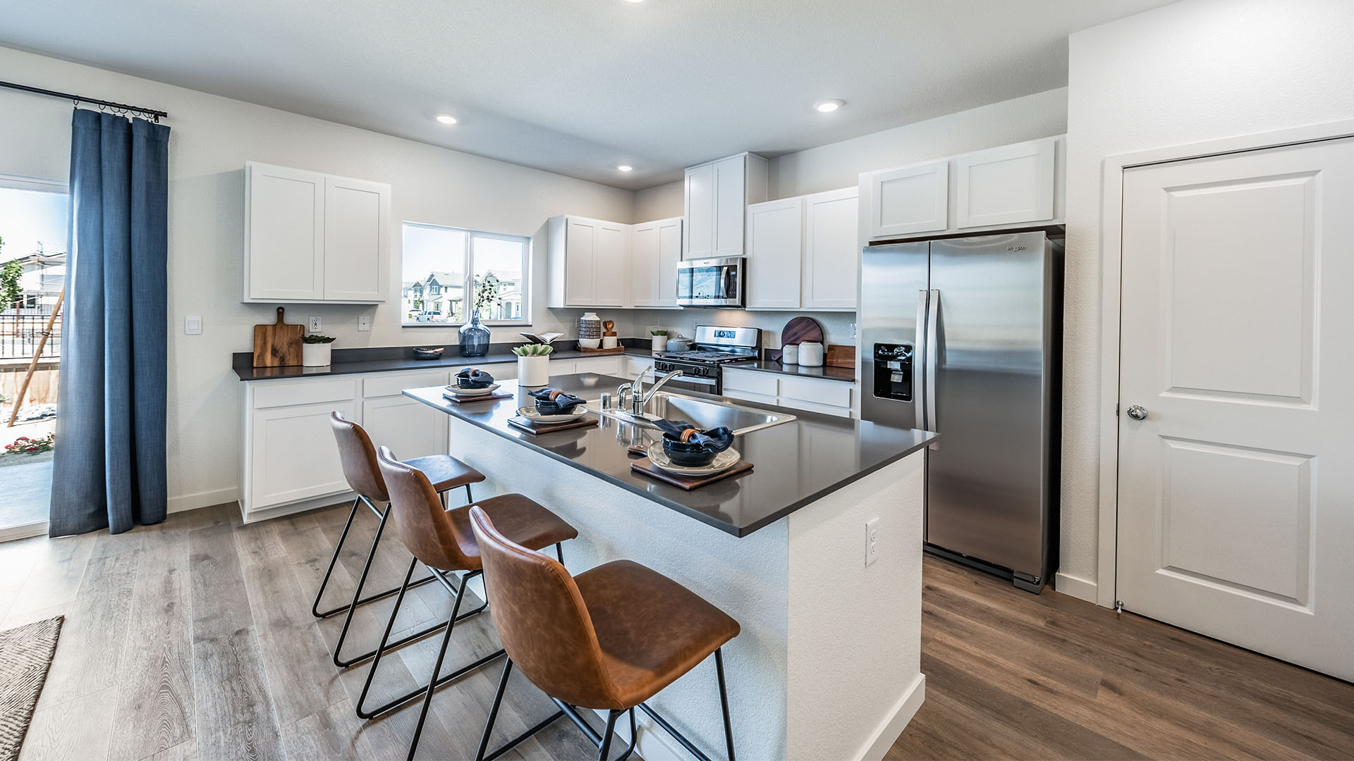 Bright modern kitchen with island and large pantry