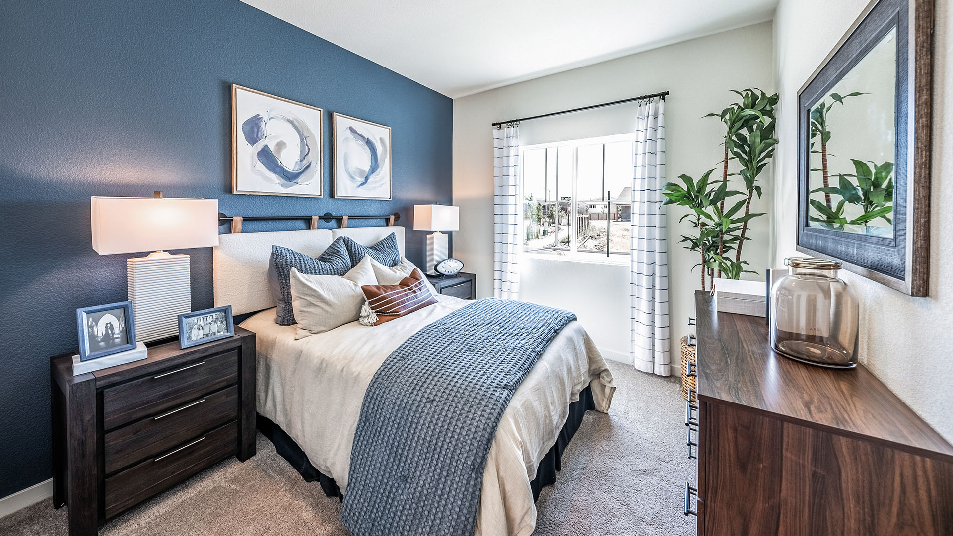 Bedroom on the first floor on the home with large window letting in natural light