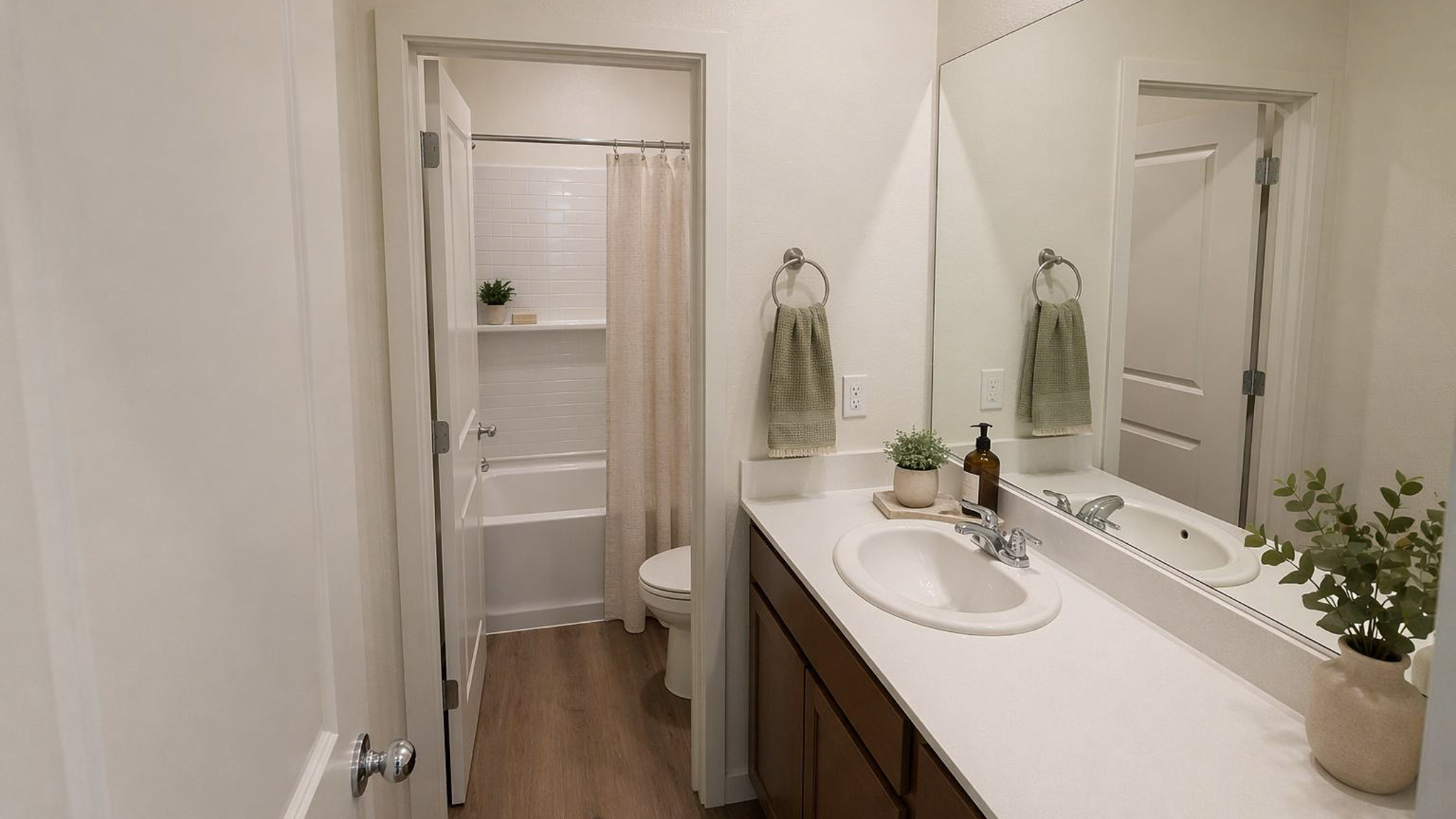 Rendered bathroom in the Glacier floorplan featuring a sink, counter space, and enclosed tub/shower and toilet.