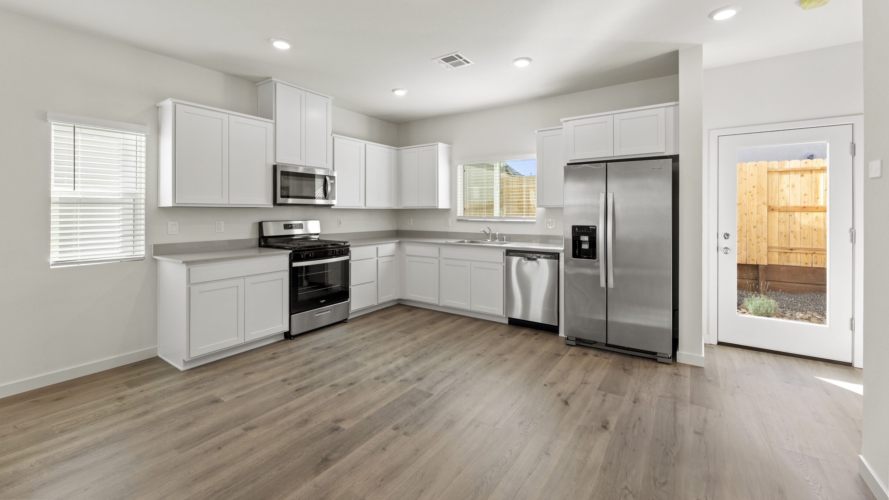 Kitchen and dining space next to back patio door