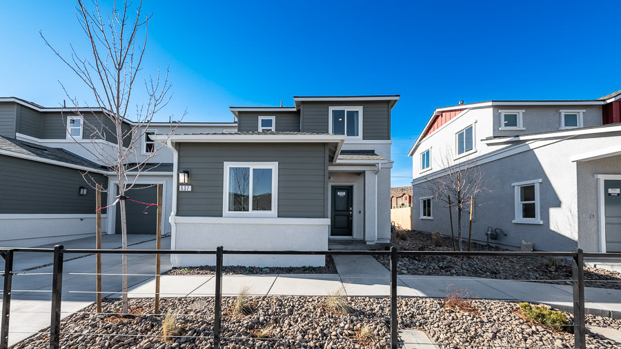 Exterior of the Saguaro model home in Phoenix, a two-story home with a combination of charcoal gray, horizontal-plank siding and stucco with a covered front entryway.
